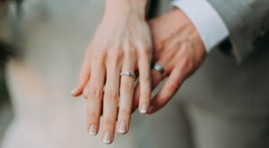 two hands with wedding rings